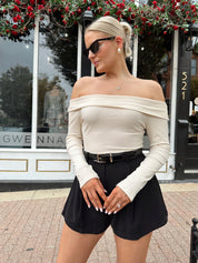 Cream colored ribbed long sleeve off the shoulder bodysuit. 