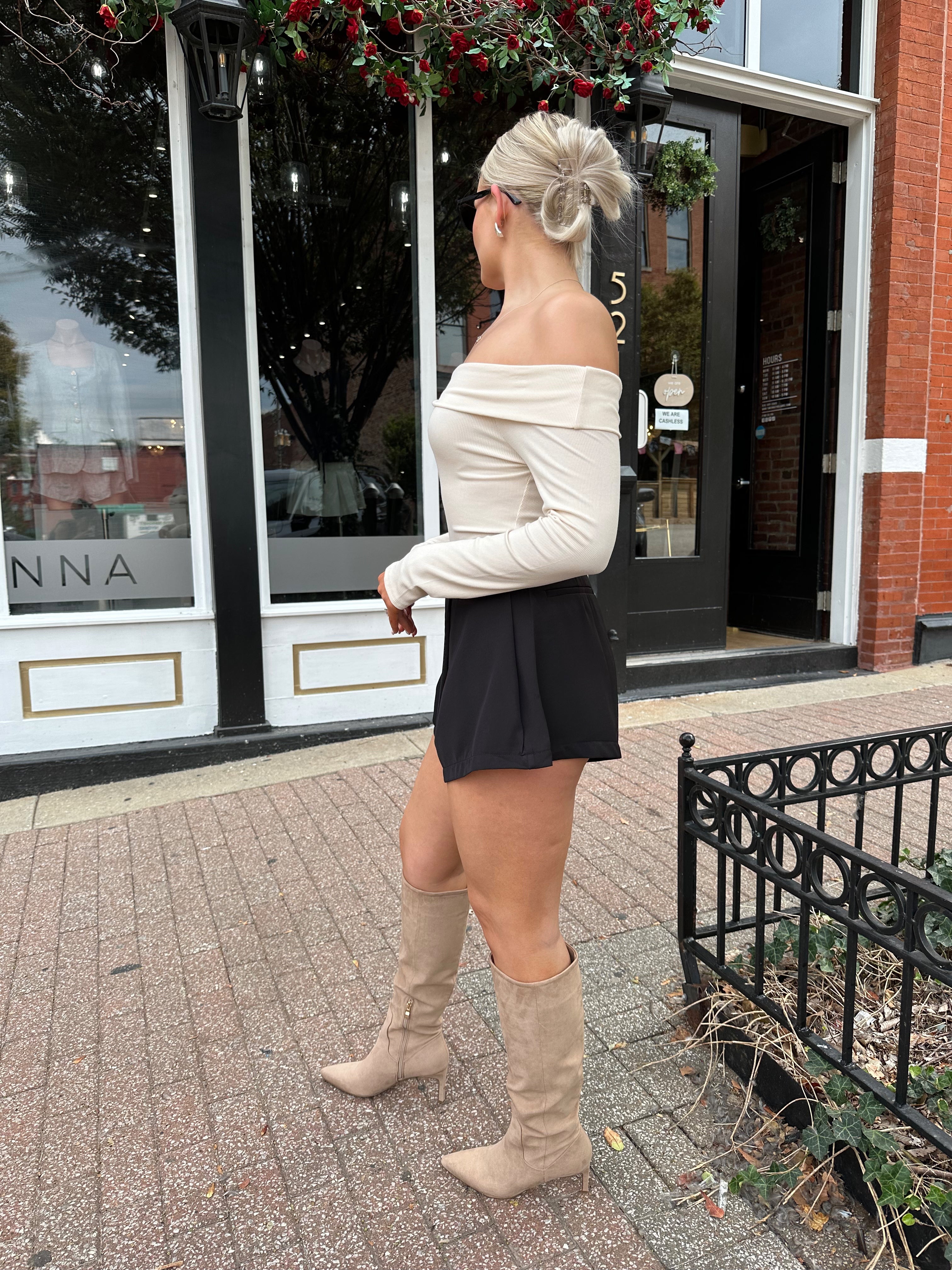Cream colored ribbed long sleeve off the shoulder bodysuit. 