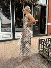 Woman wearing brown plaid satin maxi dress with keyhole tie. 