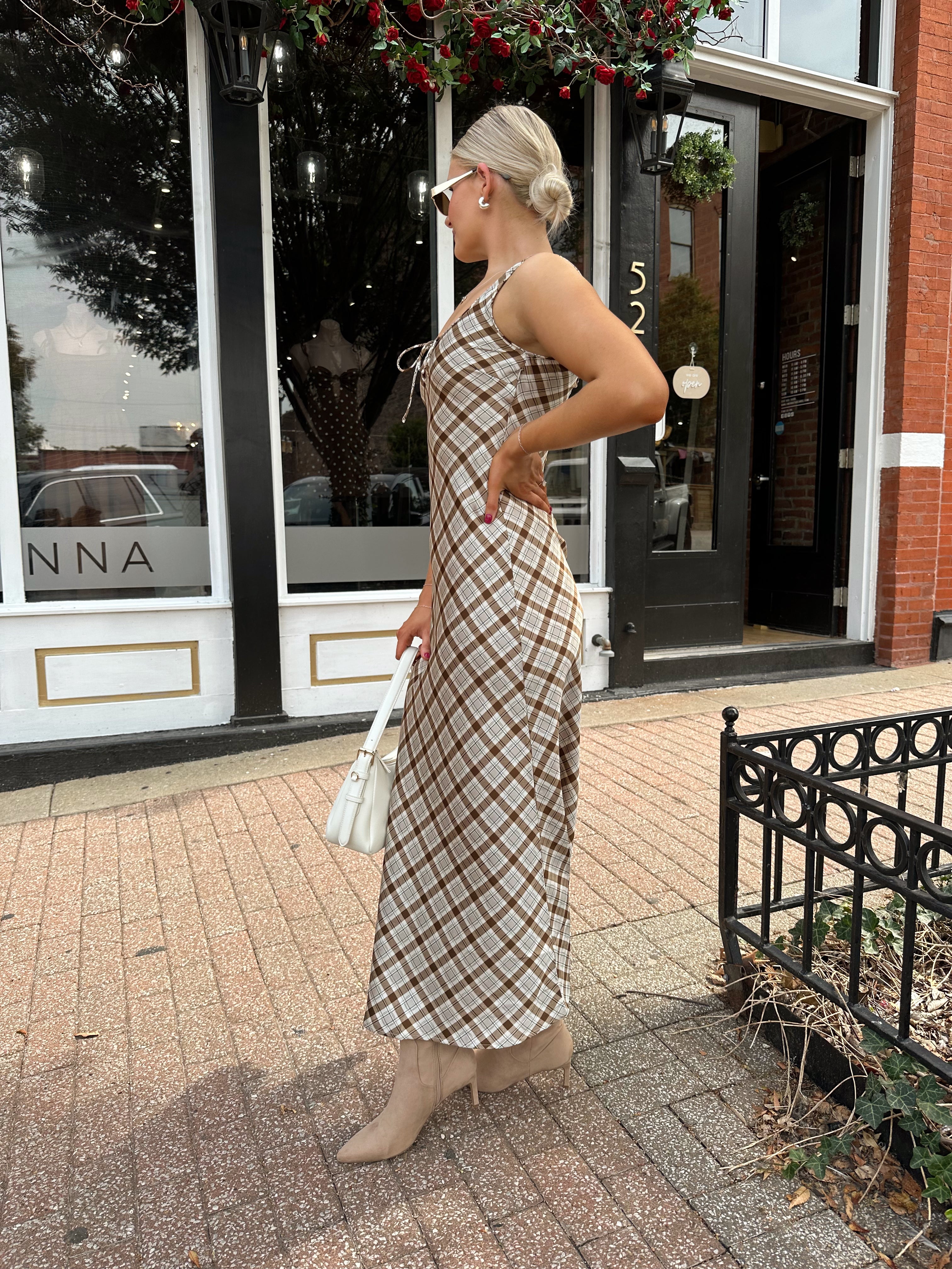 Woman wearing brown plaid satin maxi dress with keyhole tie. 