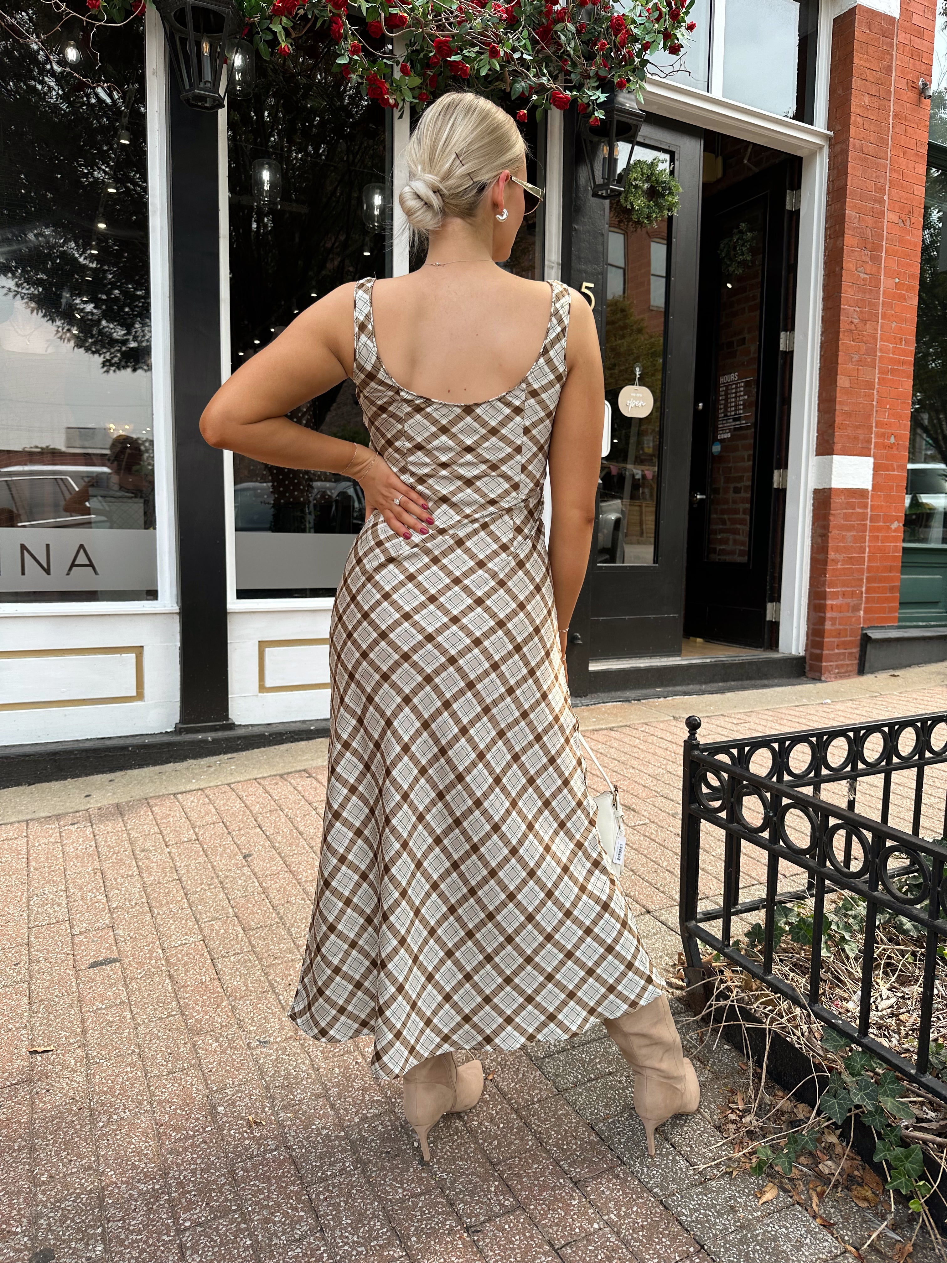Woman wearing brown plaid satin maxi dress with keyhole tie. 