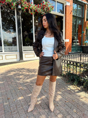 Woman wearing brown vegan leather oversized blazer. 
