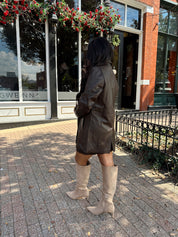 Woman wearing brown vegan leather oversized blazer. 
