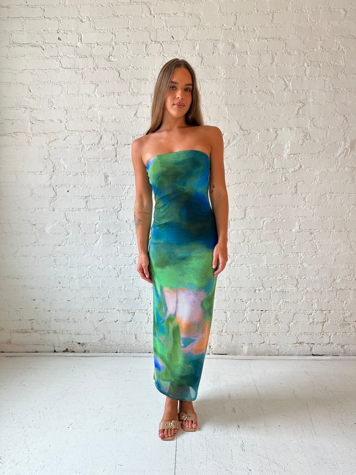 Woman wearing green watercolor pattern tube style midi dress.