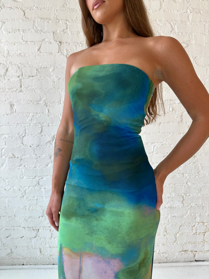 Woman wearing green watercolor pattern tube style midi dress.