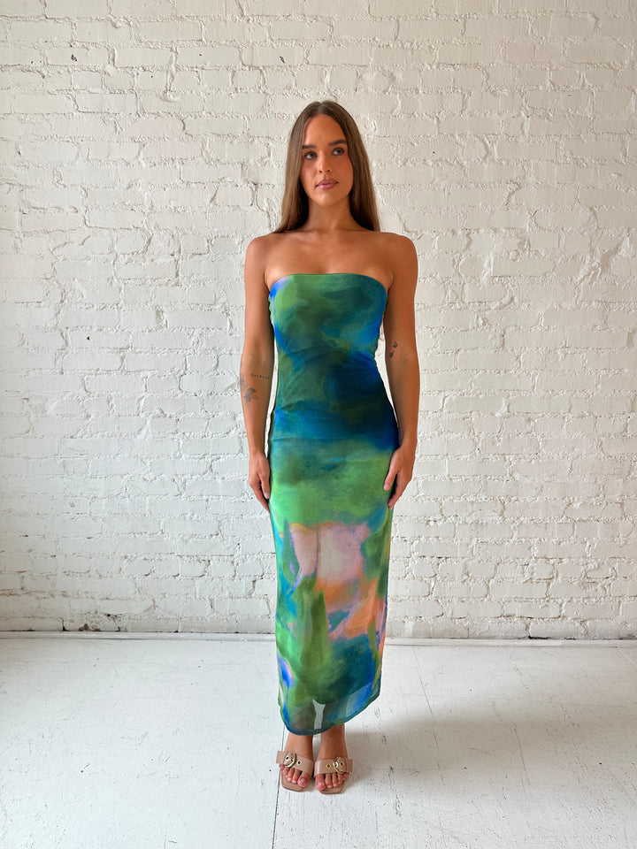 Woman wearing green watercolor pattern tube style midi dress.