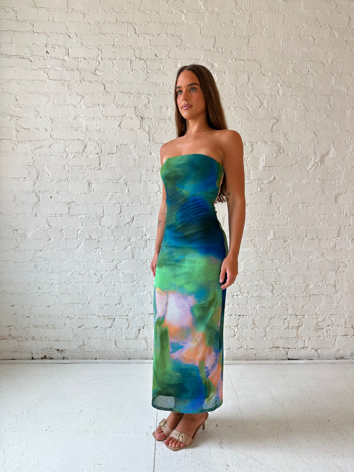 Woman wearing green watercolor pattern tube style midi dress.
