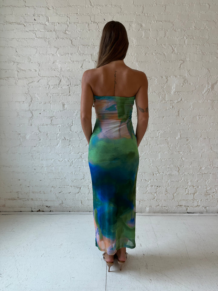 Woman wearing green watercolor pattern tube style midi dress.