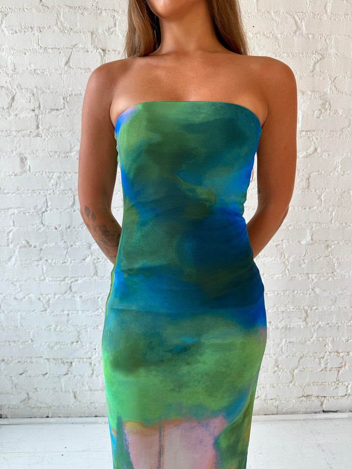 Woman wearing green watercolor pattern tube style midi dress.
