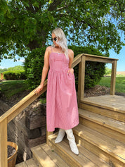 Red gingham midi dress with an open ack and adjustable spaghetti straps.