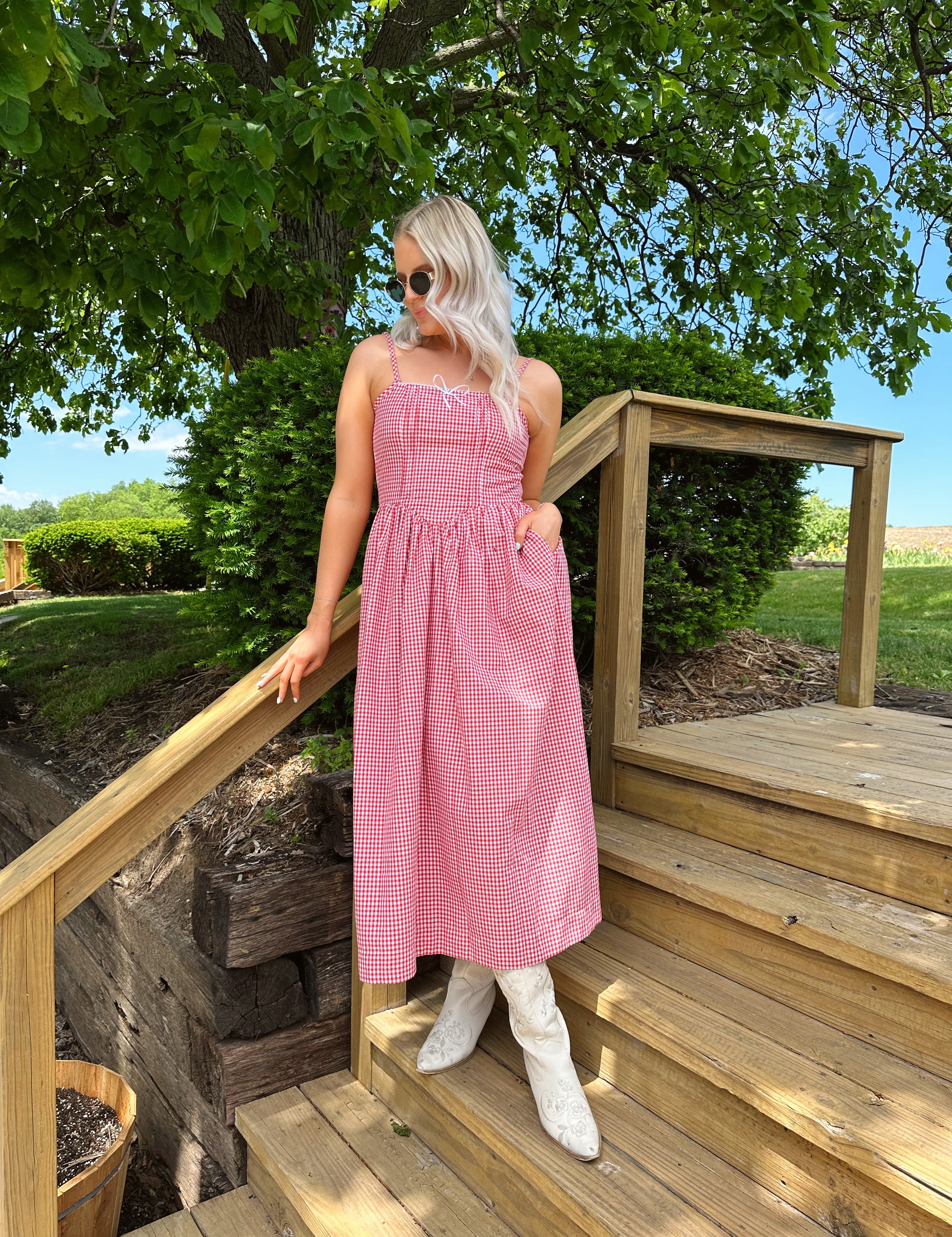 Red gingham midi dress with an open ack and adjustable spaghetti straps.