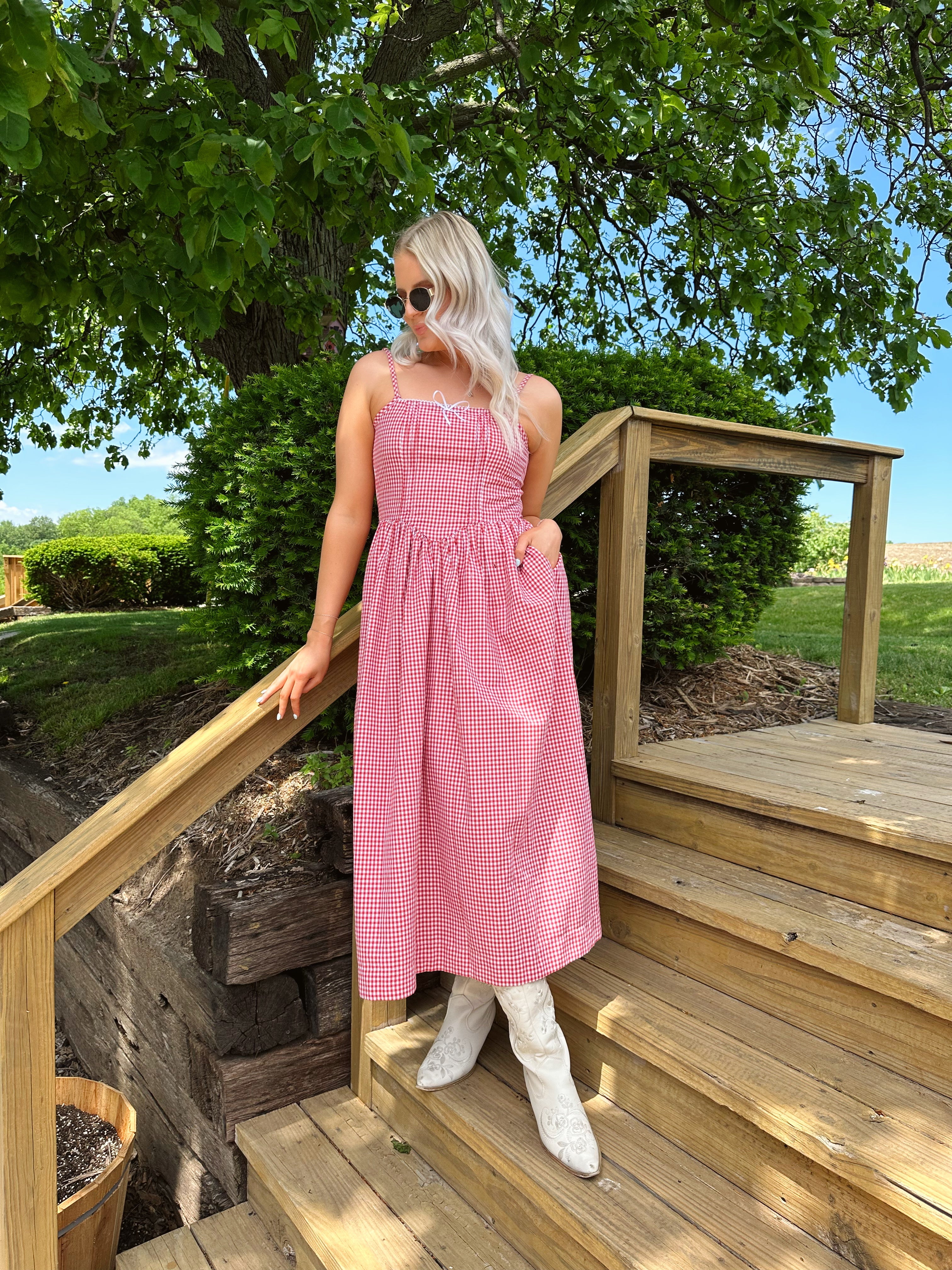 Red gingham midi dress with an open ack and adjustable spaghetti straps.