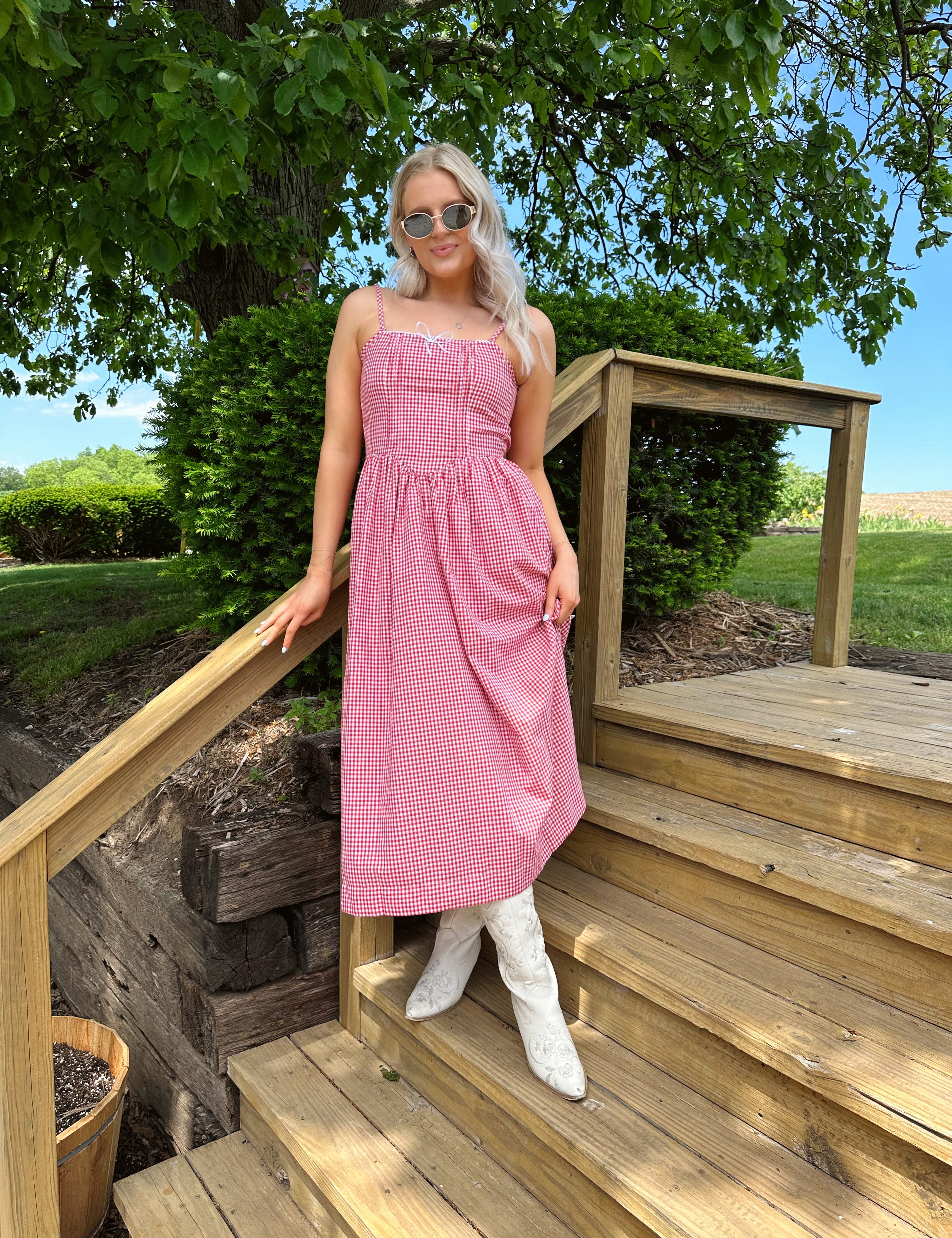 Red gingham midi dress with an open ack and adjustable spaghetti straps.