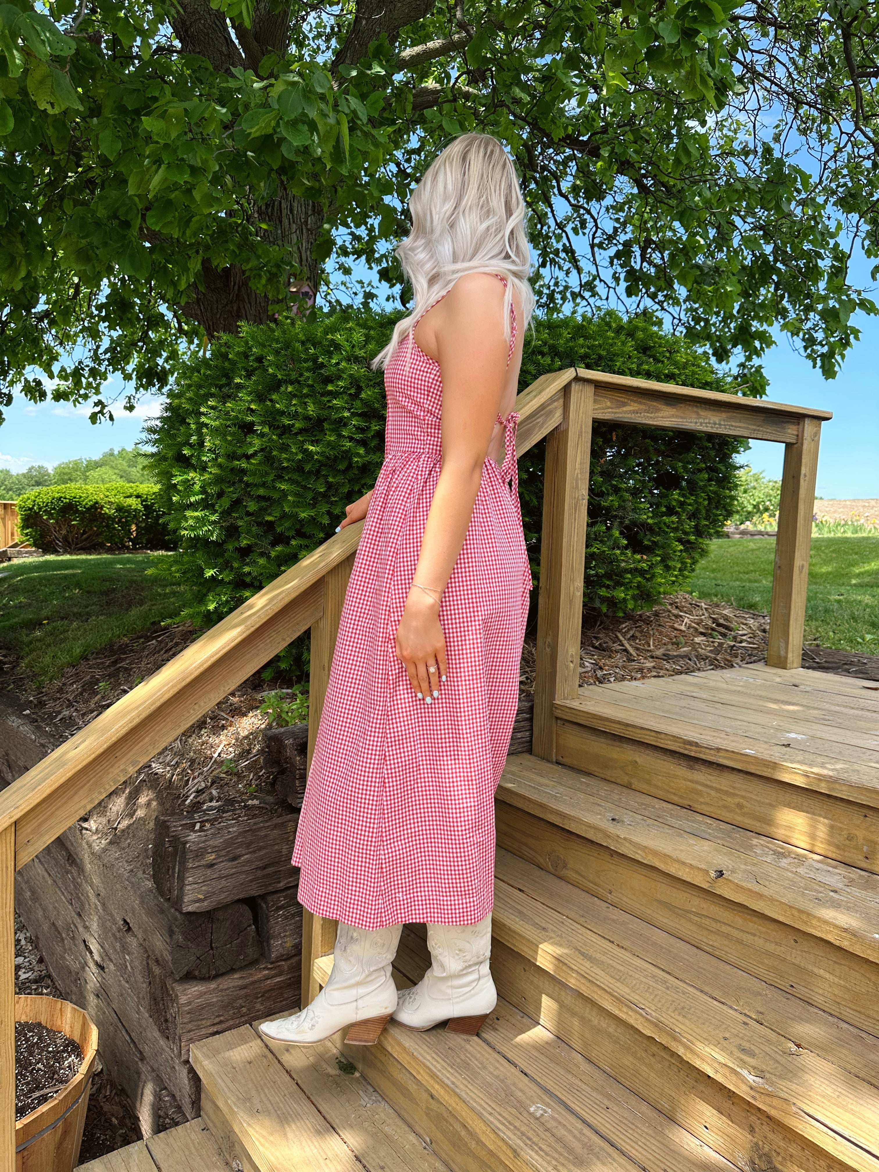 Red gingham midi dress with an open ack and adjustable spaghetti straps.
