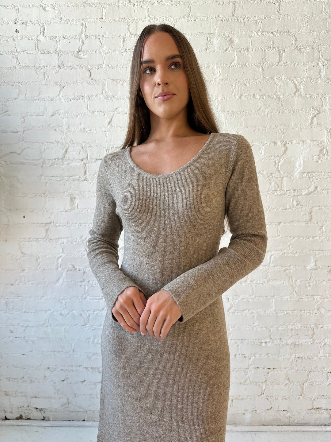 Woman wearing taupe knit sweater midi dress with heels. 