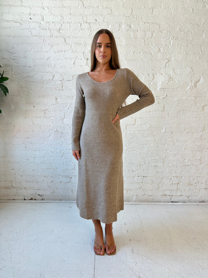 Woman wearing taupe knit sweater midi dress with heels. 