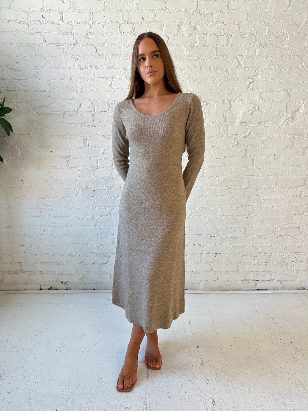 Woman wearing taupe knit sweater midi dress with heels. 