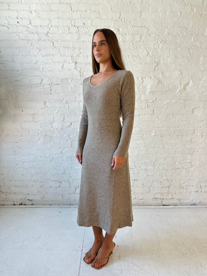 Woman wearing taupe knit sweater midi dress with heels. 
