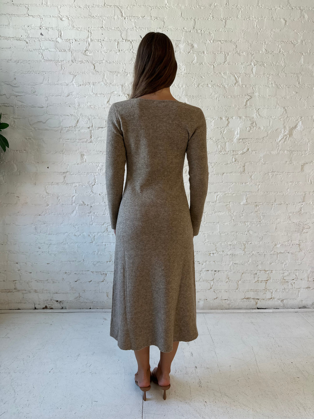 Woman wearing taupe knit sweater midi dress with heels. 