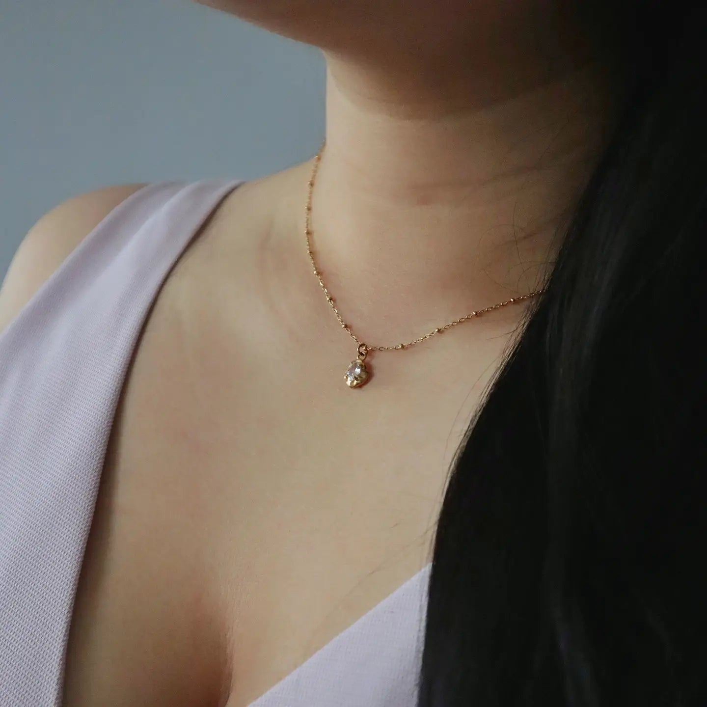 Woman wearing the Raina Pebble Gold Plated Necklace.